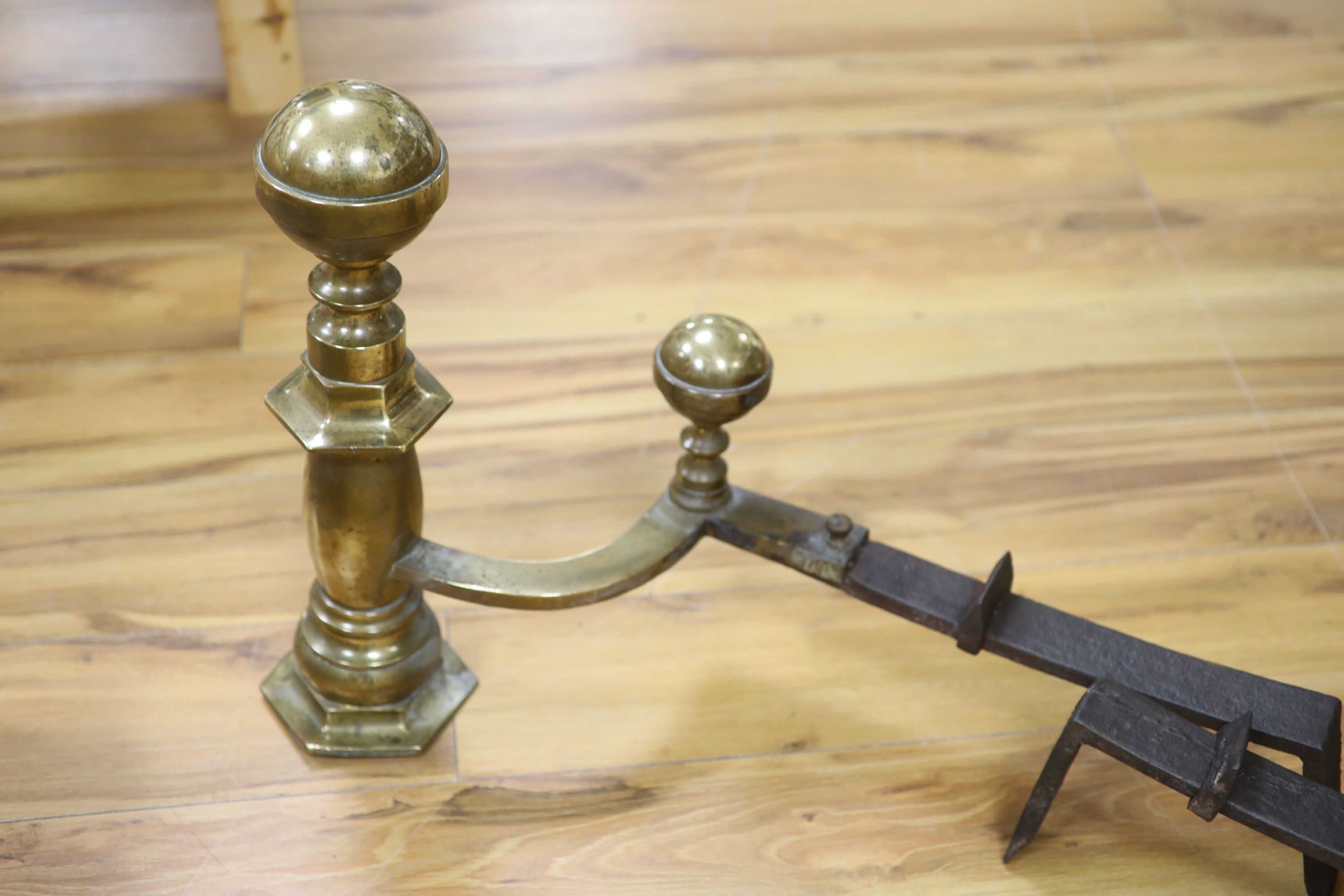 A pair of 18th century brass and wrought iron fire andirons